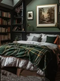 a bedroom with green walls and bookshelves filled with books, blankets and pillows