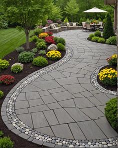 an outdoor walkway surrounded by flowers and trees