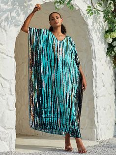 Ready to take a dip? Meet at the hot tub after dinner and show off your playful side in the Opal Kaftan. Available in a variety of vibrant hues, this maxi beach dress is a must-have for effortless style. Don't forget to pack more than one for all your beach days and fancy dinners. Details: Opal Kaftan dress Bohemian style beach cover up V-neckline Wing Sleeves Fits loose and relaxed Straight Silhouette Mid Calf length Slight Stretch fabric Available in multiple prints imported Fabric + Care: Cotton, Rayon blend. Machine wash cool with mild detergent. Line dry or tumble dry low. Opal Kaftan, Maxi dresses, beach dresses, tie dye dresses, vacation dresses, long bohemian dresses, rainbow dresses, colorful dresses, colorful maxi dresses, hippy dresses, ShoptheKei.com Turquoise Maxi Dress For Beach Cover-up, Turquoise V-neck Maxi Dress For Vacation, Beachy Multicolor V-neck Maxi Dress, Blue Long Sleeve Maxi Dress For Summer, Casual Turquoise Maxi Dress For Summer, Blue Maxi Dress For Spring Poolside, Blue Maxi Dress For Poolside Spring, Turquoise Maxi Dress For Beach Cover-up In Spring, Blue Spring Maxi Dress For Poolside