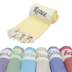 several colors of towels with the words rene on them and one is yellow, white, blue, pink, green