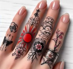 a woman's hand with tattoos on it and two rings in front of her