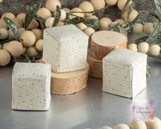 four pieces of soap sitting on top of a table next to some eggs and leaves