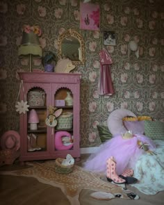 a doll house bedroom with pink furniture and floral wallpaper on the walls, including a bed