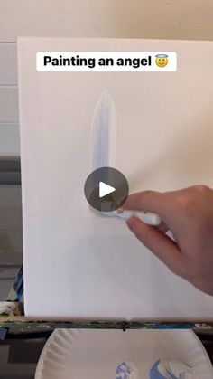 a person is painting an angel on a white box with the words'painting an angel '