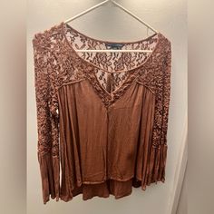 Never Worn!! Brand: American Eagle Color: Brown Lace Top With Front Tie Bell Flare Sleeve Size Small Soft And Comfortable!! Brown Lace Tops For Spring, Beige Lace Trim Tops For Fall, Fall Beige Lace Top Blouse, Fitted Brown Top With Lace Trim, Brown Fitted Lace Top, Fitted Brown Lace Top, Spring Brown Top With Lace Trim, Brown Lace Top, Bell Sleeve Tops