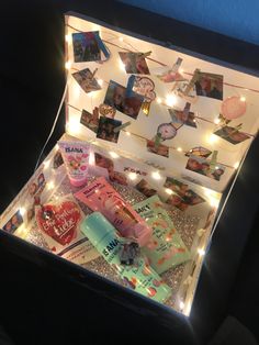 an open box filled with lots of different items and lights on the inside of it