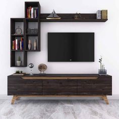 an entertainment center with bookshelves and a flat screen tv mounted on the wall