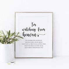 a framed print with the words i'm watching from heaven and a potted plant