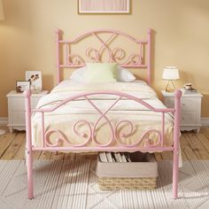 a pink metal bed frame in a bedroom