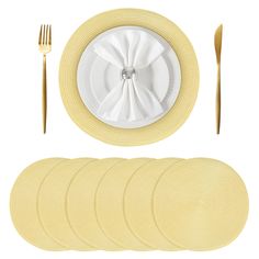 a set of four place settings with forks and napkins on the plate next to each other