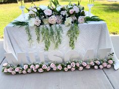 a table with flowers and the word msh on it is set up for a wedding reception