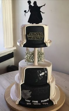 two tiered cake with star wars decorations on it