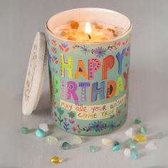 a birthday candle is sitting next to some candies