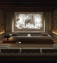 a large screen in the middle of a room with couches and chairs around it