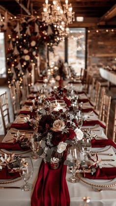 the table is set with red napkins and place settings