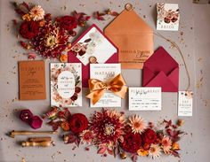 the wedding stationery is laid out with flowers, cards and envelopes for guests