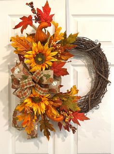 a fall wreath with sunflowers and leaves