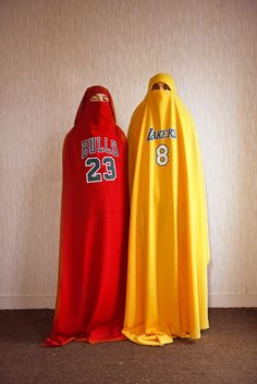 two basketball capes sitting next to each other in front of a wall with the number 29 on it