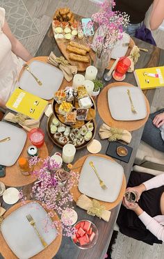 people sitting around a table with plates and food on it