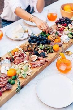 a table topped with plates and bowls filled with different types of food on top of it