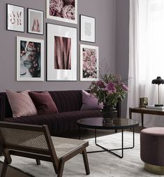 a living room filled with furniture and pictures on the wall above it's coffee table