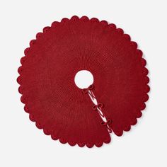 a red doily with a hook on it