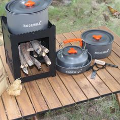 the camping stove is set up with cooking utensils