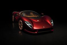 a red sports car sitting in the dark