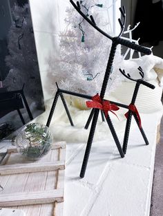 two black and white reindeer statues on a table