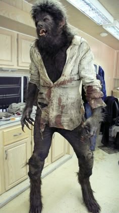 a man dressed as a gorilla standing in a kitchen