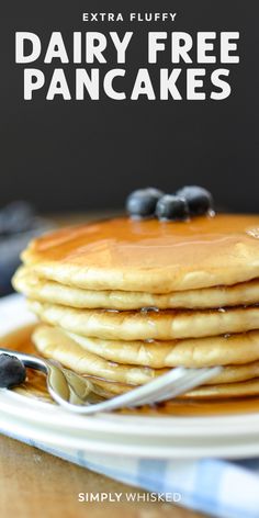 a stack of pancakes with blueberries on top and the words extra fluffy dairy free pancakes