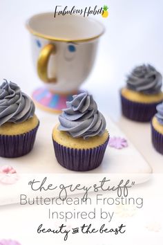 cupcakes with frosting sitting on a plate next to a teacup and saucer