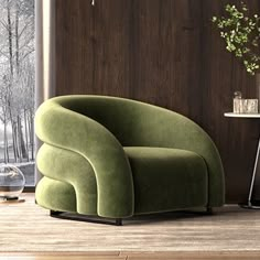 a green chair sitting in front of a window next to a table with a potted plant