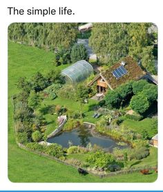 an aerial view of a farm with a pond