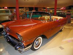 an antique car is on display in a museum