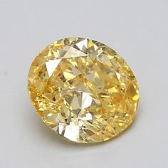 an oval yellow diamond on a white surface with the center cut out to show it's lust