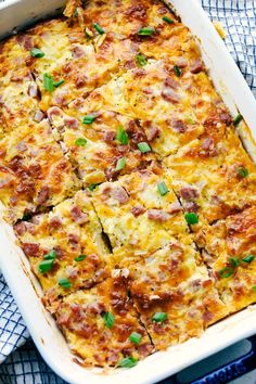 a casserole with ham and cheese in a white dish on a blue towel