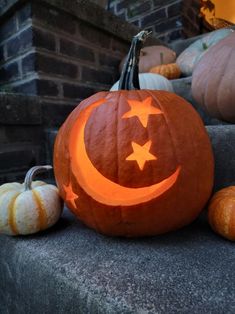 a pumpkin carved to look like a crescent and stars