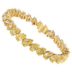 This beautiful tennis bracelet features 28 perfectly matched Pear Shaped yellow Diamonds set at an angle for a very elegant and sophisticated look. Measure 6.5 inches. Set in 18 Karat Yellow Gold. Luxury Dazzling Yellow Gold Diamond Bracelet, Elegant Luxury Yellow Gold Diamond Bracelet, Yellow Diamond Bracelet, Bracelet Tennis, Yellow Diamonds, Yellow Jewelry, Tennis Bracelet Diamond, Pear Shaped Diamond, All That Glitters