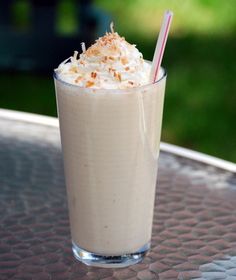 a tall glass filled with milk and topped with whipped cream