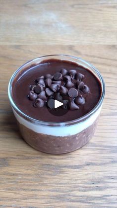 a bowl filled with chocolate pudding on top of a wooden table