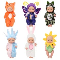 four baby dolls are dressed in different costumes