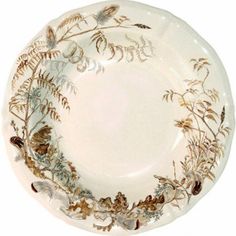 a white plate with flowers and leaves on it's rim, against a white background