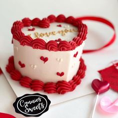 a heart shaped cake sitting on top of a table