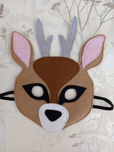 a felt deer mask with antlers on it's head and eyes are shown