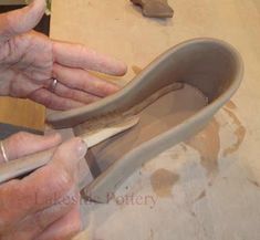 an older woman is working on a shoe with her hands in the shape of a shoe