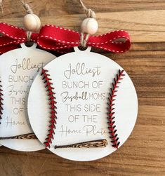 baseball ornament with red ribbon on wooden table