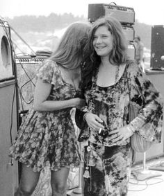 two women standing next to each other on a boat