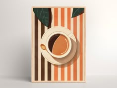 a cup of coffee on top of a striped table cloth next to a green leaf