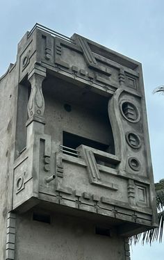 a concrete building with a clock on the side